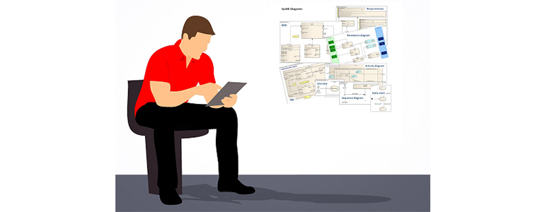 Man reviewing SysML work on his computer